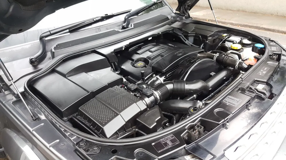 An engine bay after a deep clean, plastics dressed and free of leaves and dust