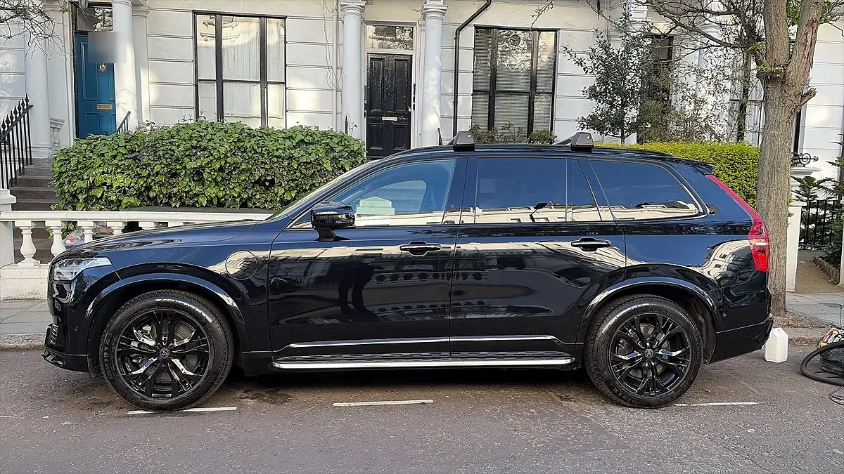 A black Volvo XC90 side profile after a Full Valet, paint reflecting the white terrace behind