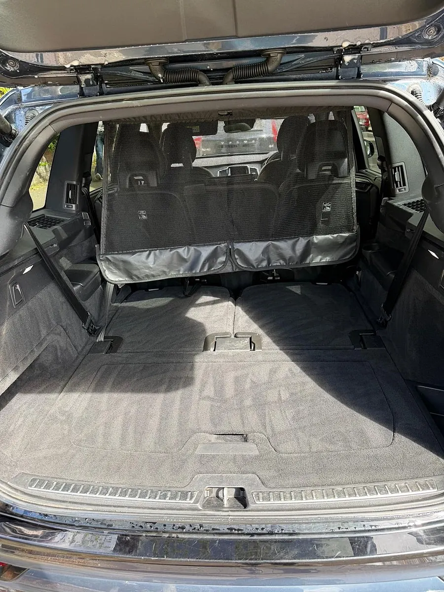 A large SUV boot vacuumed and emptied, rear seats folded behind the cargo net