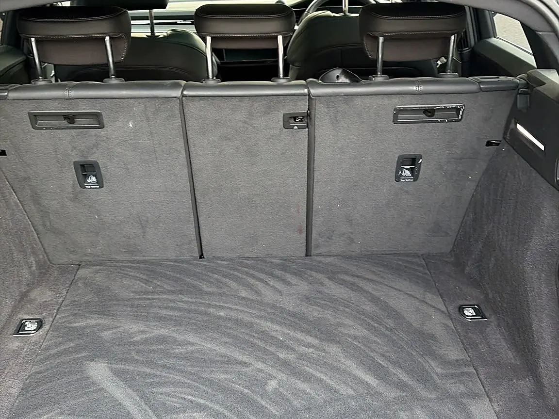 An SUV boot freshly vacuumed, with brush lines left in the carpet