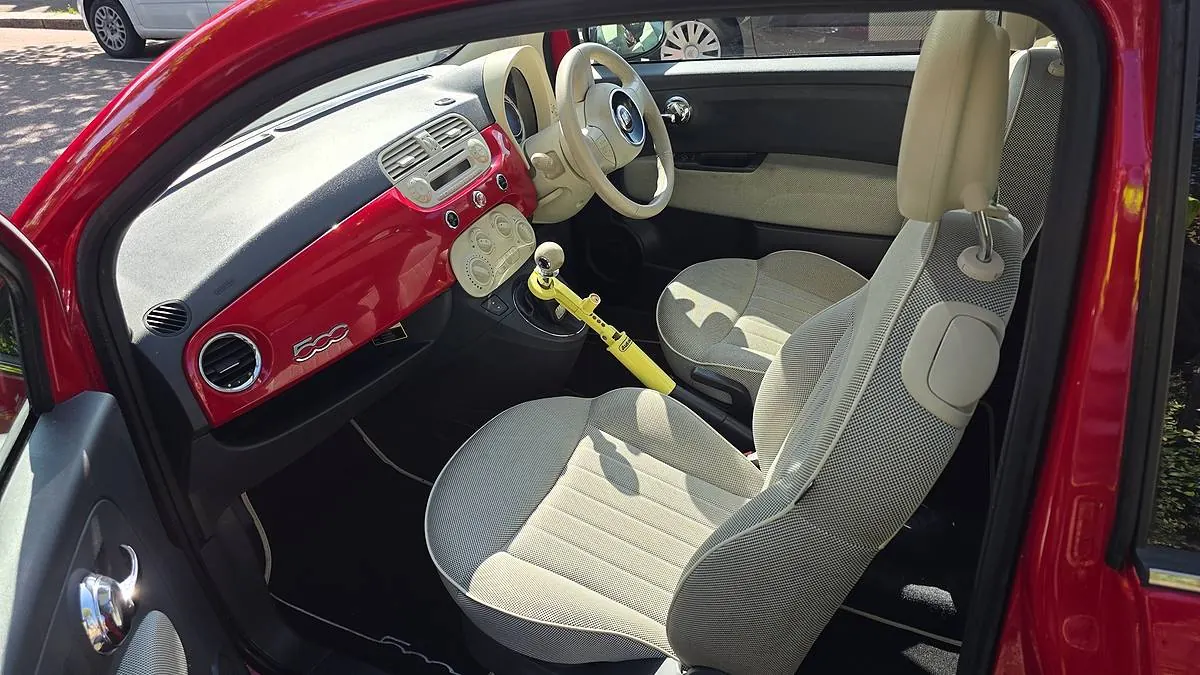 Cream seats and a red dashboard inside a Fiat 500 after a Mini Valet