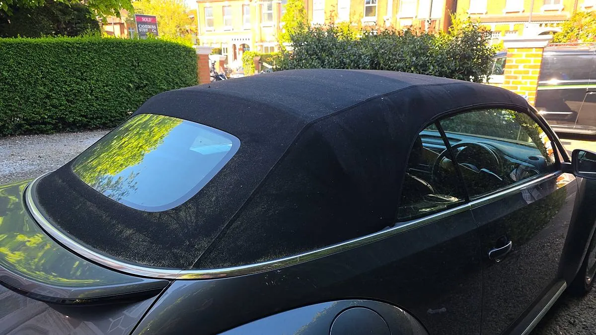 Black fabric soft top of a VW Beetle Cabriolet after a soft roof deep clean